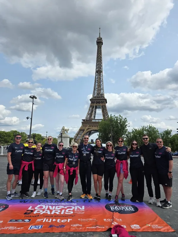 The London to Paris support crew photographed together in front of the Eiffel Tower