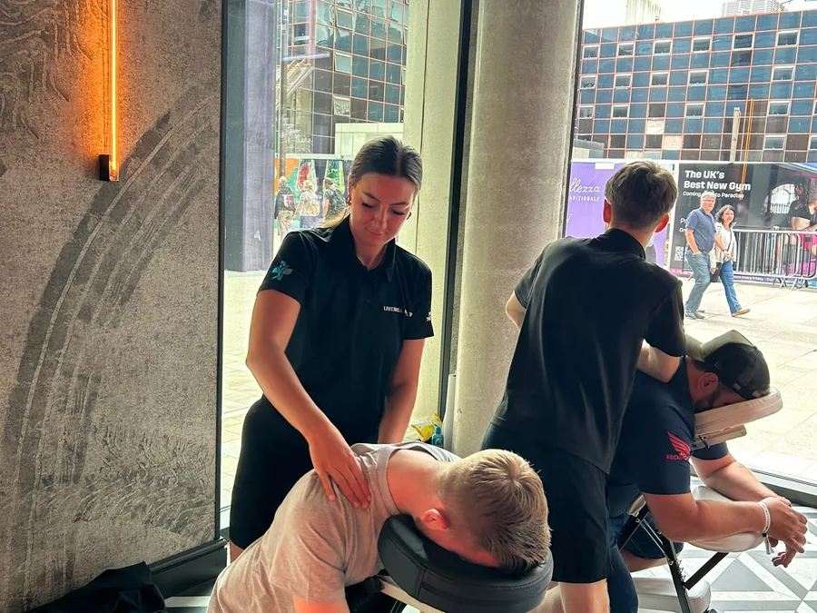 Seated chair massage being delivered to office workers at a city-centre corporate event